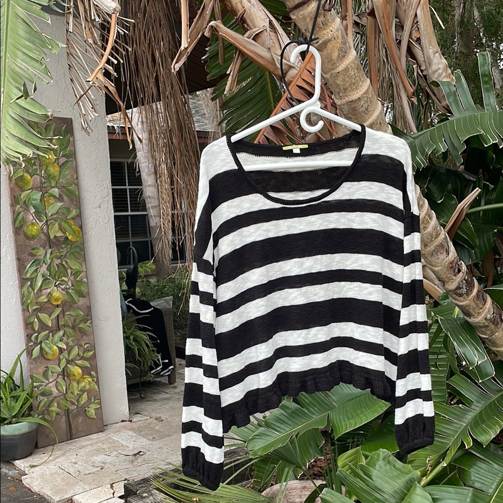 oversize striped knit top with ruffled him and puff sleeves